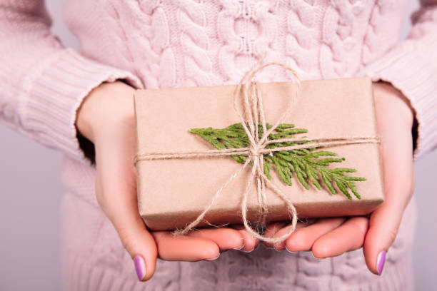 istock Female Holding Rustic Decorated Christmas Gift 1279880203