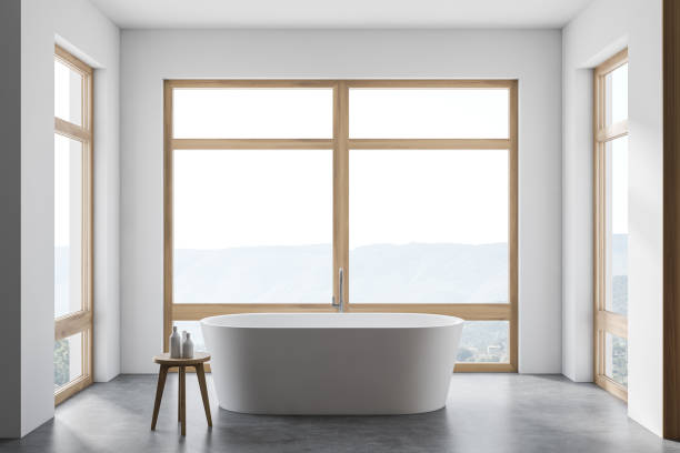 istock Modern white bathroom interior with tub and windows 1279882857