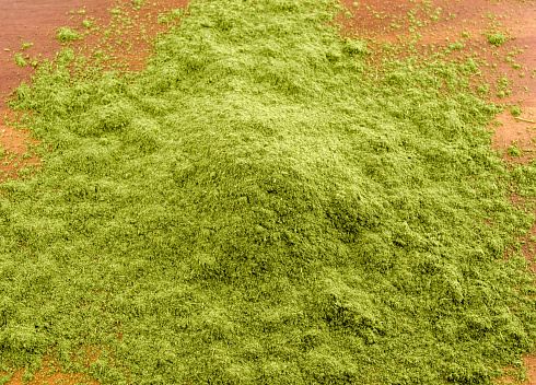 Close-up of moringa powder on surface.  Overhead horizontal view.