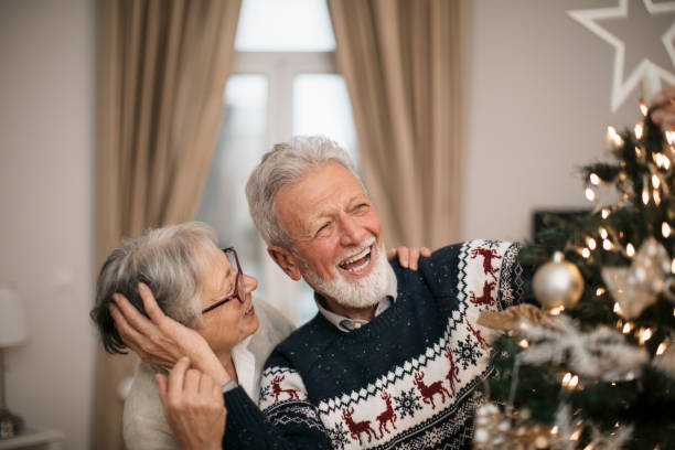 istock Happy family decorating a Christmas tree with ornaments 1279885863
