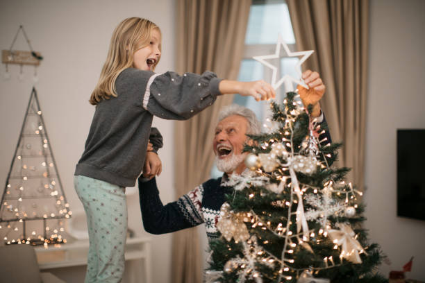 istock Happy family decorating a Christmas tree with ornaments 1279885907