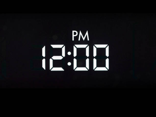 istock Black with White Clock Twelve PM Digital Numbers Color Photo 1279886071