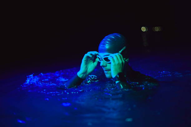 istock authentic triathlete swimmer having a break during hard training on night neon gel light 1279888594