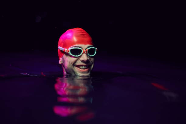 istock authentic triathlete swimmer having a break during hard training on night neon gel light 1279888704