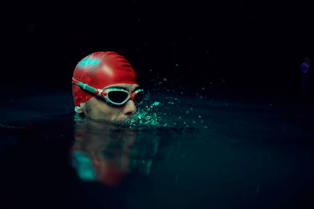 istock authentic triathlete swimmer having a break during hard training on night neon gel light 1279888707