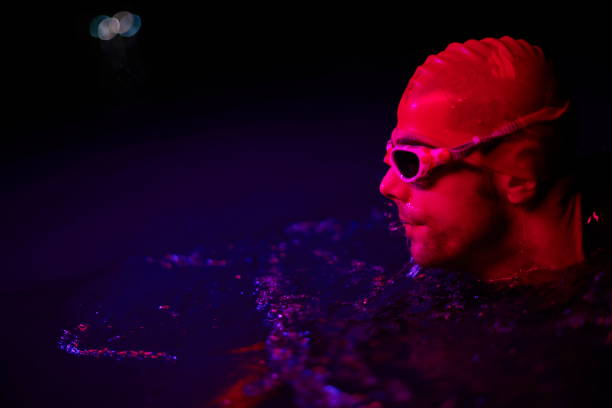 istock authentic triathlete swimmer having a break during hard training on night neon gel light 1279888718