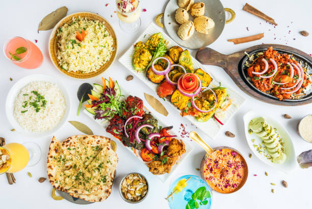 Table top view of Indian food. Table top view of Indian variety of vegetarian and non vegetarian food displayed on table. indian food stock pictures, royalty-free photos & images