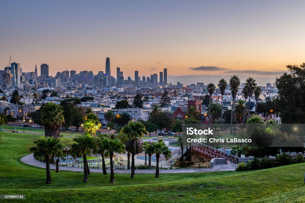 Mission Dolores Park at Dawn The sun rises over the San Francisco skyline from Mission Dolores Park. San Francisco - California Stock Photo