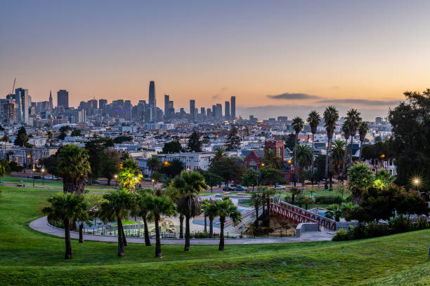 Mission Dolores Park at Dawn The sun rises over the San Francisco skyline from Mission Dolores Park. northern california stock pictures, royalty-free photos & images