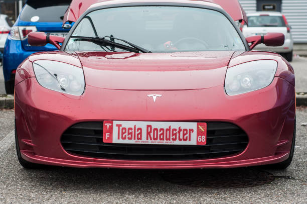 Front view of red tesla car parked in the street, the famous electric sport car Mulhouse - France - 10 November 2019 - Front view of red tesla car parked in the street, the famous electric sport car elon musk stock pictures, royalty-free photos & images