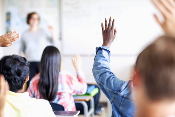 istock Teenage students asking questions in diverse classroom 1279894935