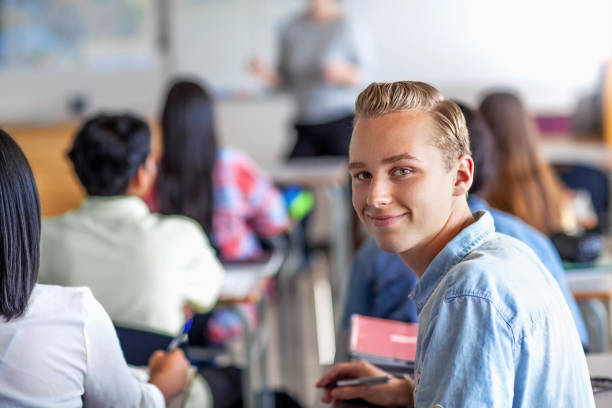 istock Portrait of smiling student learning in classroom 1279895722