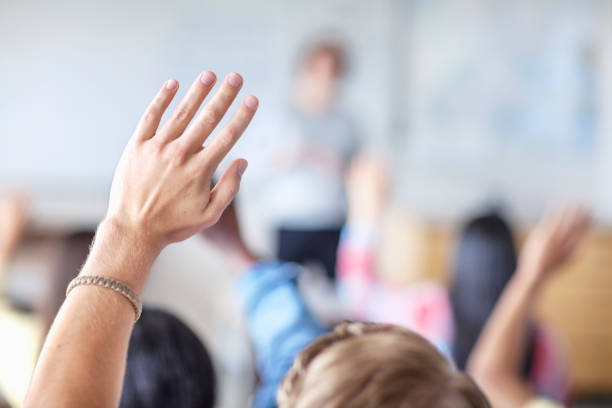 istock Teenage student raising hand in classroom 1279895767