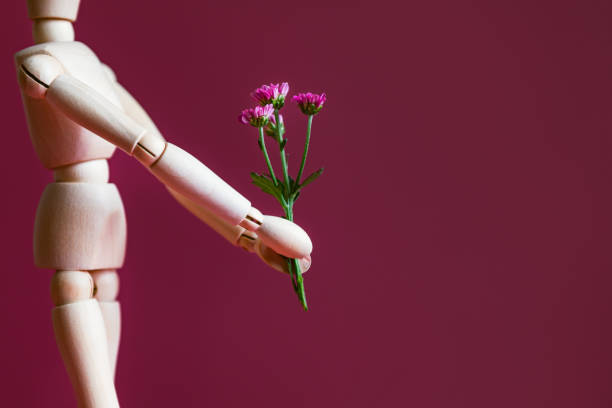 istock Wood man holding flowers 1279895786