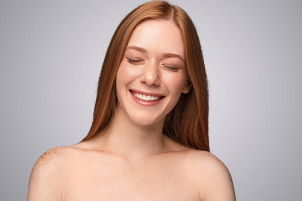 istock Freckled woman laughing with closed eyes 1279895872
