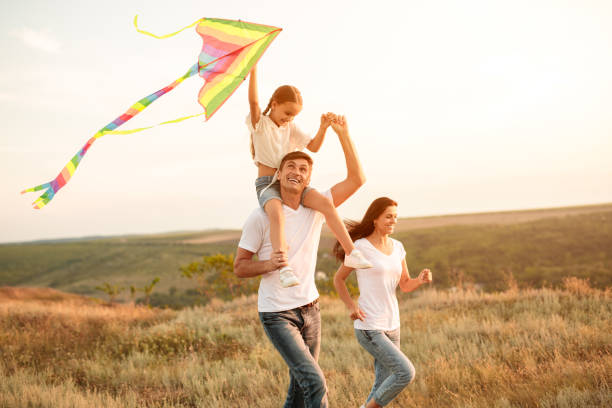 istock Delighted family running with kite 1279895914