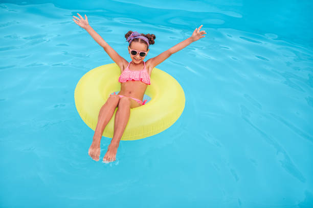 istock Happy kid enjoying summer vacation in pool 1279895942