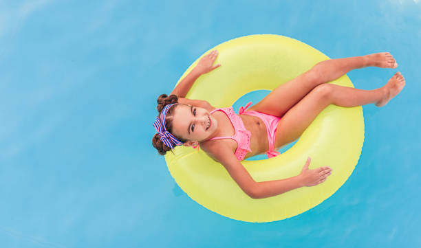 istock Optimistic child resting on tube in pool 1279895952