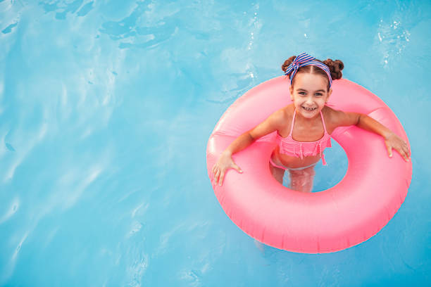 istock Happy girl swimming in pool 1279895970