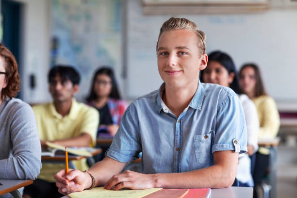 istock Portrait of student at desk studying in classroom 1279896190