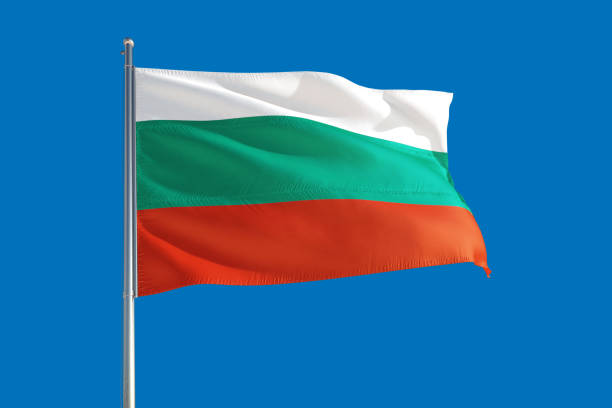 istock Bulgaria national flag waving in the wind on a deep blue sky. High quality fabric. International relations concept. 1279896339