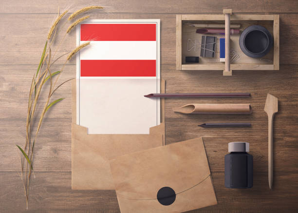 istock Austria invitation, celebration letter concept. Flag with craft paper and envelope. Retro theme with divide, ink, wooden pen objects. 1279896368