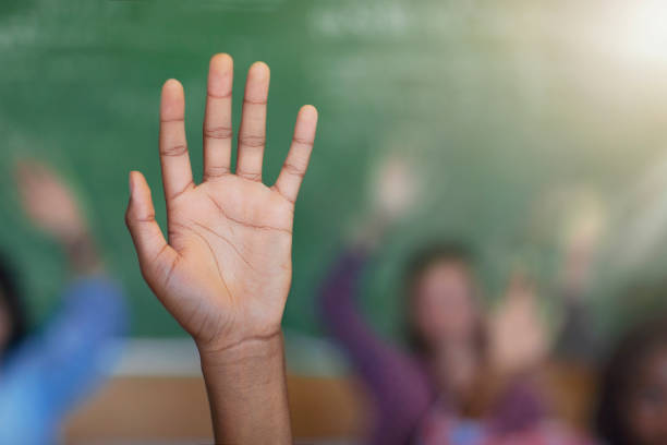 istock Cropped hands of diverse multi-cultural student answering questions in classroom 1279902357