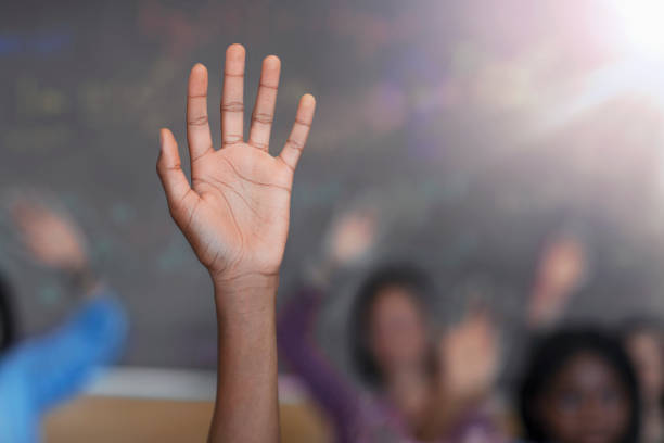 istock Cropped image of diverse multi-cultural student with hand raised in class 1279902384
