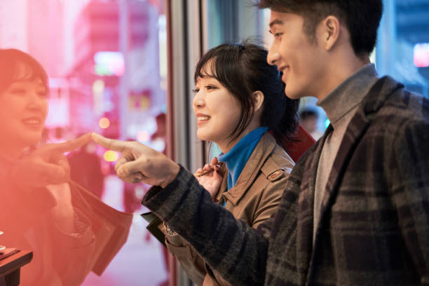 istock happy young asian couple looking into shop window 1279903540