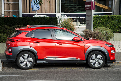 Mulhouse - France - 24 September 2020 - Profile view of orange color Hyundai Kona parked in the street