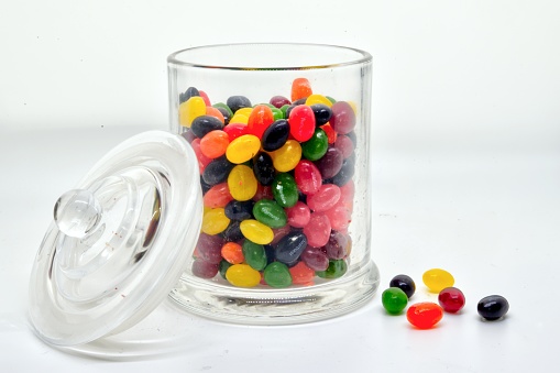 A jar full of marbles as would be used in a contest on a white background