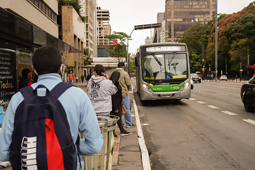Passenger bus movement on Avenida Paulista in the city of Sao Paulo on a rainy day.