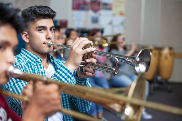 istock Portrait of male Middle Eastern ethnicity student practicing trumpet in classroom 1279906568