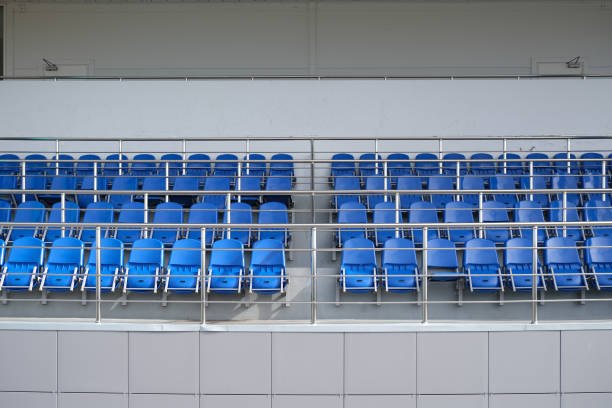 istock Blue chairs in the stadium. Empty tribune for spectators. 1279910004