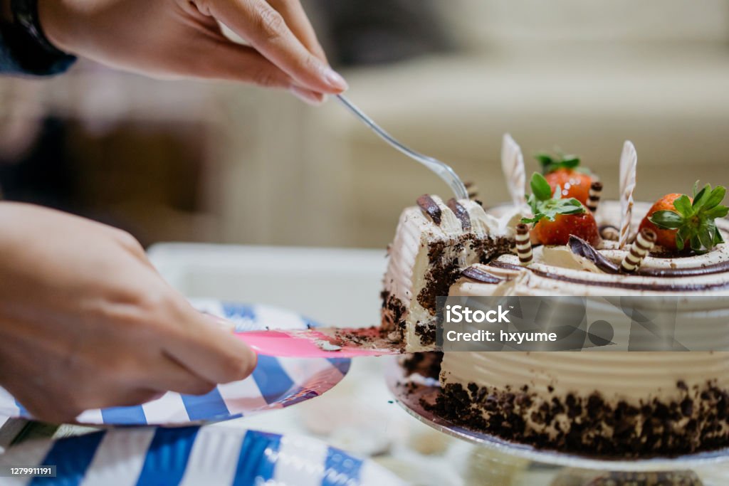 Close up of asian woman slicing a birthday cake Cake Stock Photo