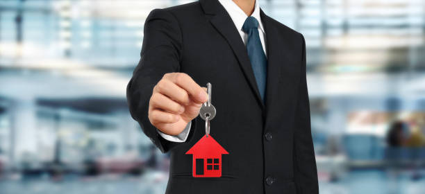 istock Real estate agent handing over house keys 1279913115