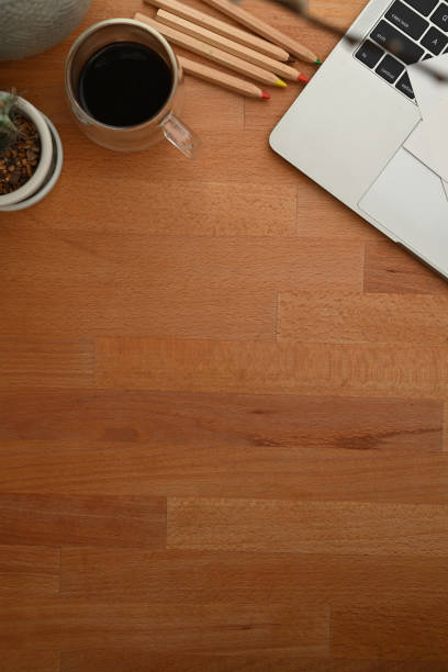 istock Wooden table with copy space, coffee cup , laptop and stationery 1279915995