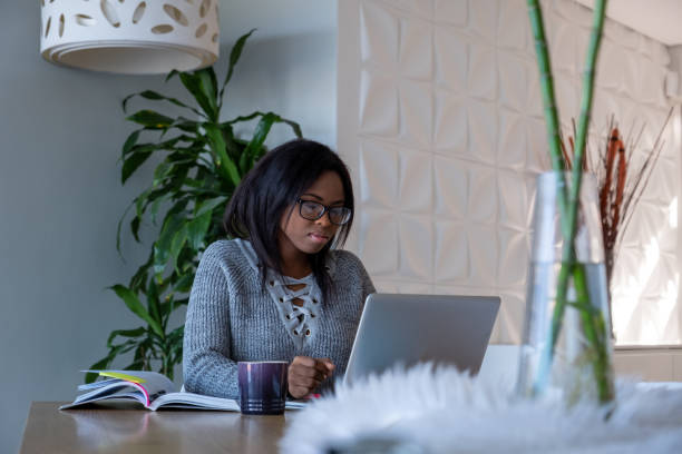 istock Young adult sits at the dining room table and studies 1279916859