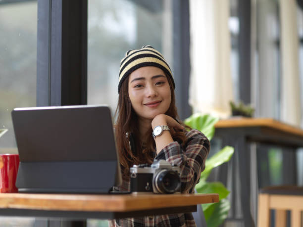istock Female photographer smiling to the camera while working with tablet in workspace 1279917148