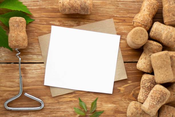 istock Blank sheet for writing on a wooden background. Surrounded by wine corks, corkscrew and green leaves. Vintage story 1279920474
