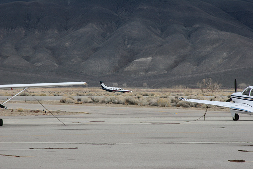 On Feb 23, 2005 This Piper Malibu Mirage reported an engine out to Bishop Airport, Bishop California requesting runway wind conditions, and his intentions to make an emergency engine out landing.  This series of images depicts the steep turn and decent he performed to make a perfect engine out landing.  After landing he had enough momentum to coast onto a taxiway where he stopped.  The pilot and passenger were uninjured.  The aircraft was checked out by a mechanic and it was determined that the air/fuel mixture was improperly set while crossing the Sierra Nevada Mountains causing the engine to die and not restart.  At full resolution, the propeller can clearly be seen to be stopped.