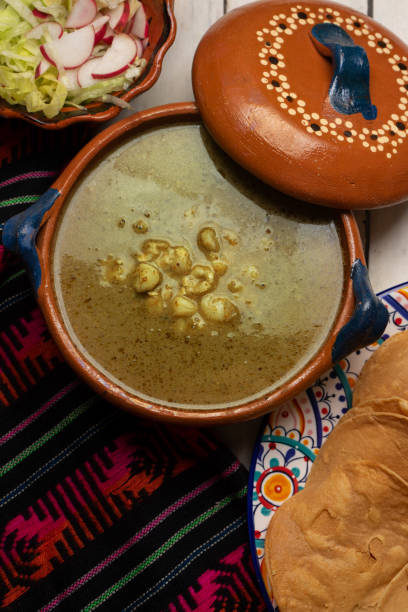 istock Mexican green pozole in cazuela on white background 1279925991
