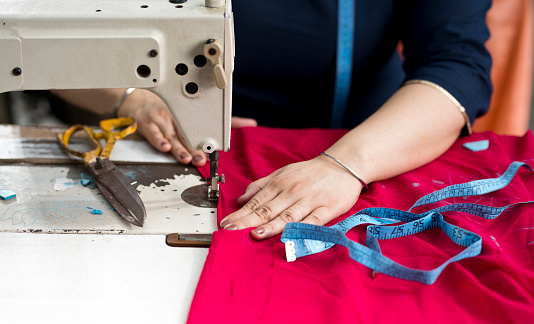 Woman textile worker using swing machine