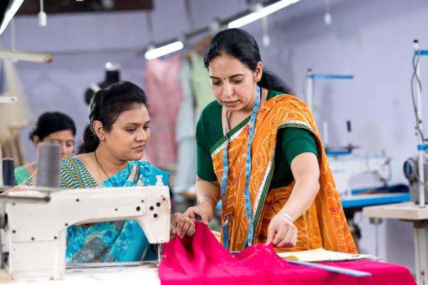 istock Senior inspector explaining women textile worker sewing garment on production line 1279929167
