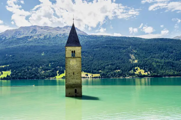 The famous bell tower in the Lake of Reschen - Lago di Resia in South Tyrol, Italy. During WW2 a dam was build and put the village under water, only the tower is still visible now.