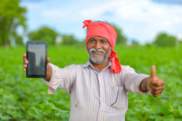 istock Indian farmer Showing a mobile screen at agriculture field 1279932296