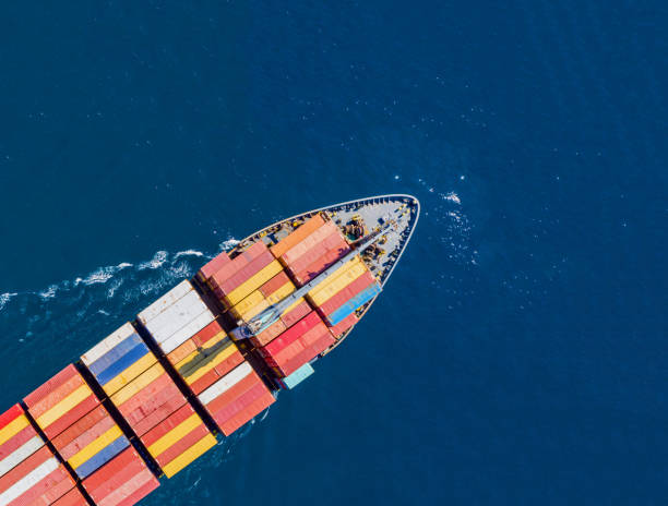 istock Cargo ship full loaded with containers, blue sea background, top view 1279932520
