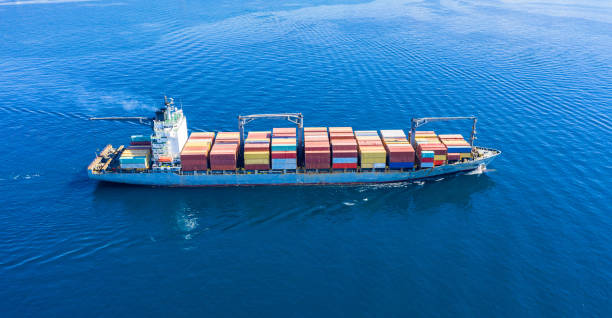 istock Cargo ship full loaded with containers, blue sea background 1279932525