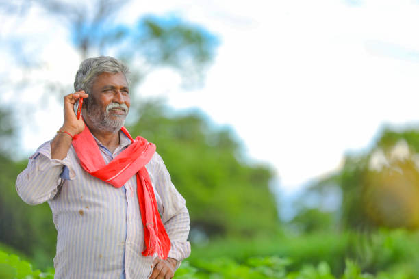 istock Indian farmer talking mobile phone at Agriculture field 1279933162