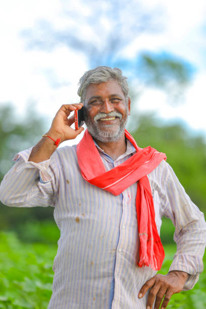 istock Indian farmer talking mobile phone at Agriculture field 1279933292